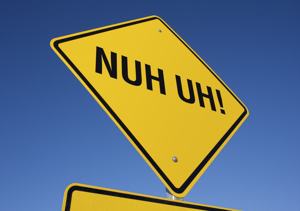 "Nuh Uh" yellow street sign.